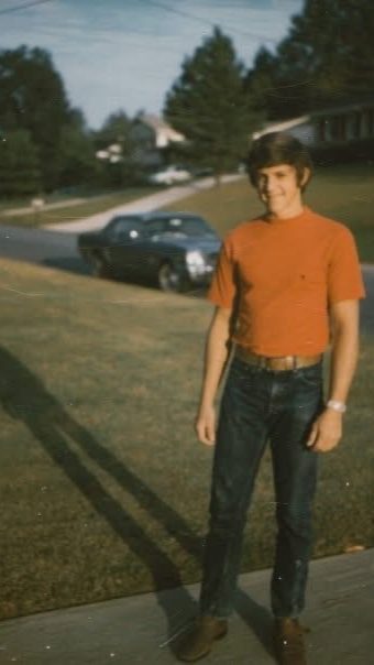 David's dad standing in the street beside his '65 Mustang, circa 1972
